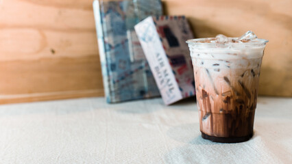 Iced chocolate milkshake, Summer refreshment drinks on wooden background in the cafe.