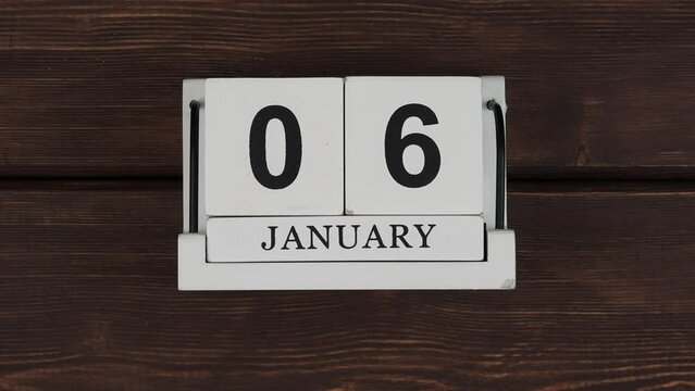  January. wood calendar with date month and day on a wooden table. change of days. 