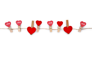 Clothespins with red hearts on rope isolated on white background. Top view. Greeting card. - Powered by Adobe