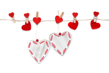 Fototapeta premium Clothespins with red hearts on rope isolated on white background. Top view. Greeting card.