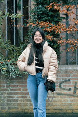 Full-length portrait of an attractive young woman in the street.