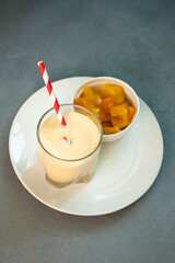 Yellow Indian mango yoghurt drink Mango Lassi or smoothie with turmeric and saffron.