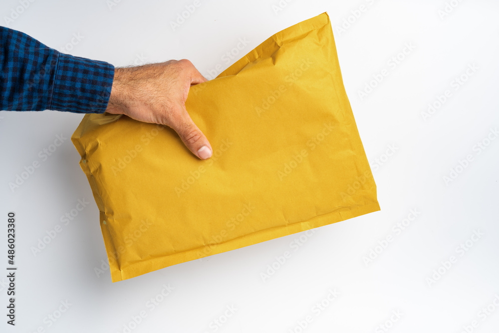 Poster Male hand holding parcel post against white background