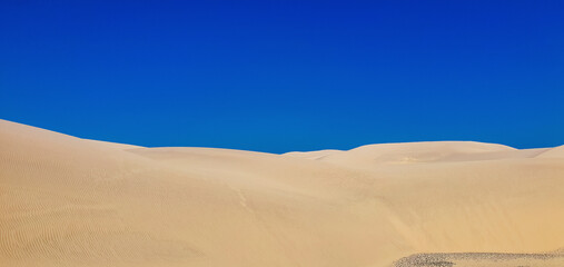 Fototapeta na wymiar Reddish sand dunes on the island of Gran Canaria.