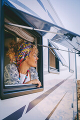 People tourist enjoy freedom with camper van travel summer holiday vacation lifestyle. Happy woman outside the motorhome window with closed eyes feel the nature outdoor with joyful