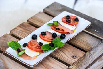 mozzarela as a caprese salad with black olives