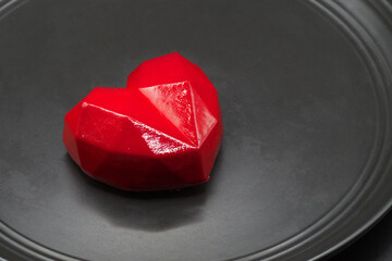 Red pastry souffle on a black background