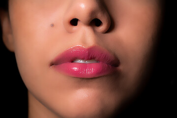 Full pink lips of a brunette woman
