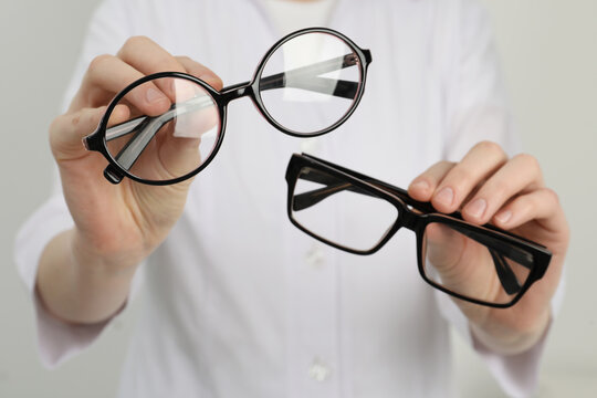 Woman with different glasses on light background, closeup