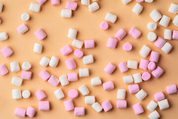 Fluffy marshmallows on beige studio background, top view