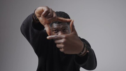 Young African framing with the fingers - director or photographer freelancer. High quality 4k footage