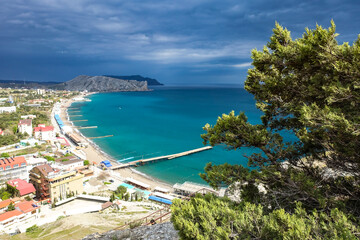 Crimea - May 2021. A line of beaches in the city of Sudak. View from the Genoese fortress on the Sudak Bay. Sudak.