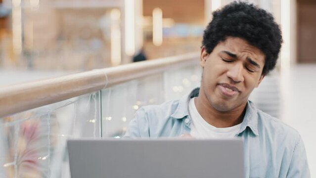 African american guy sad frustrated upset disappointed business man losing online bets getting rejected from bank email problems loser male laptop stress low battery computer breakdown error mistake