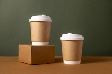 Coffee craft paper cups with place for logo on green and brown background, natural color, for menu and restaurants 