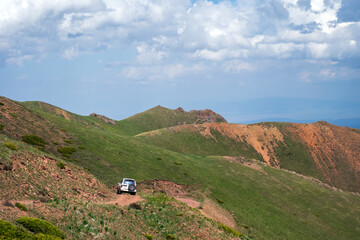 Off-road vehicle on dangerous off-road mountain trail background. Offroad journey, travel. Summer travel concept. Mountain road.