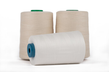 Spool of sewing thread, isolated on white background. Colored yarns used by factories in the clothing industry. Threads wound on the spool. Colored reels