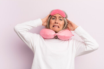 middle age woman feeling stressed, anxious or scared, with hands on head. flight passenger concept