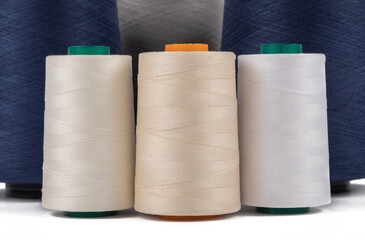 Spool of sewing thread, isolated on white background. Colored yarns used by factories in the clothing industry. Threads wound on the spool. Colored reels