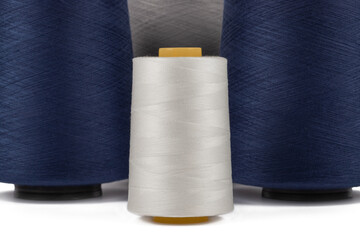 Spool of sewing thread, isolated on white background. Colored yarns used by factories in the clothing industry. Threads wound on the spool. Colored reels