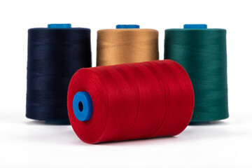 Spool of sewing thread, isolated on white background. Colored yarns used by factories in the clothing industry. Threads wound on the spool. Colored reels