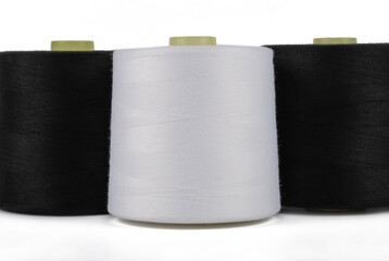 Spool of sewing thread, isolated on white background. Colored yarns used by factories in the clothing industry. Threads wound on the spool. Colored reels
