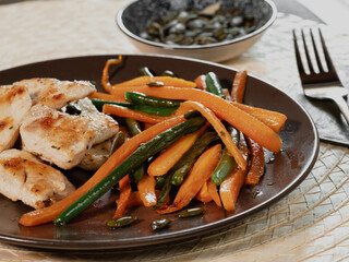 dish of chicken and vegetable: carrots and green beans. Healthy food, meal with proteins and vegetable. fork .