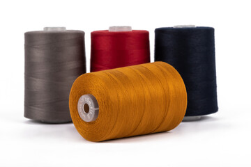 Spool of sewing thread, isolated on white background. Colored yarns used by factories in the clothing industry. Threads wound on the spool. Colored reels