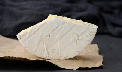 bergader blue cheese on a black wooden board, delicious snack