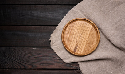 empty round brown wooden plate on table, top view