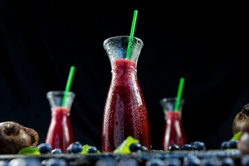 Juice with Beetroot, blueberries and mint in glass jar with fruits and vegetables on the wooden table. Detox, diet, healthy, vegetarian drink concept