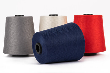 Spool of sewing thread, isolated on white background. Colored yarns used by factories in the clothing industry. Threads wound on the spool. Colored reels
