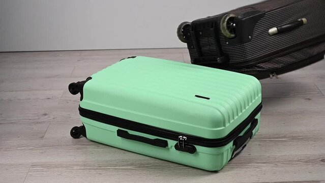 The suitcase is casually thrown onto another suitcase. Baggage transportation.