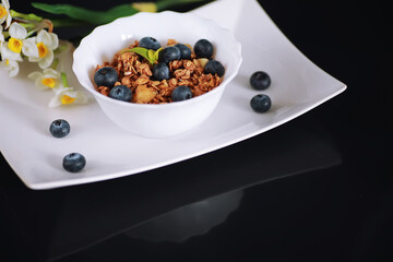 A healthy breakfast cereal with milk and fruit. Oat and corn flakes with chocolate and yogurt. The concept of healthy and vegetarian food.