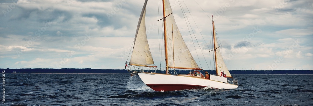 Wall mural Old wooden two masted yacht sailing in the Baltic sea during the storm. Sport, regatta, cruise, tourism, recreation, transportation. Panoramic view, seascape