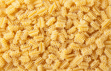 Uncooked radiatori pasta background