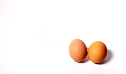 two chicken eggs on the right on a white background