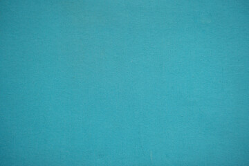 a bright turquoise blue textured woven fabric background