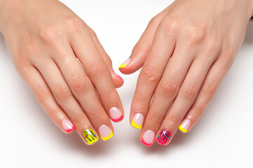 Bright, summer nail design. French colored yellow, coral manicure on short square nails close-up on...