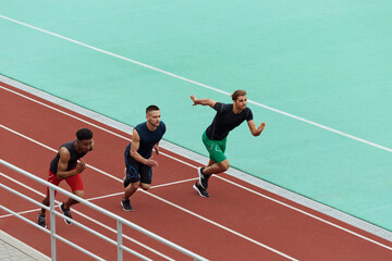 Obraz premium Sports men running on treadmill on stadium
