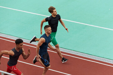 Sports men running on treadmill on stadium