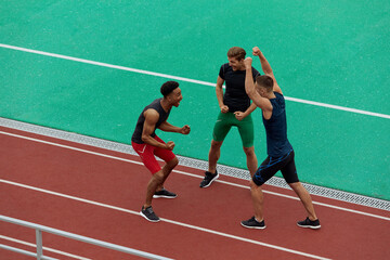 Obraz premium Sportsmen celebrating triumph or win on treadmill