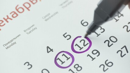 Close-up of the twelfth day of the calendar, signed with a purple pen