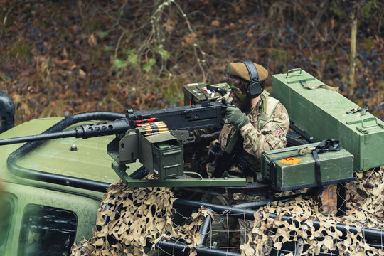 Aiming to fire attack from a protected patrol vehicle of British military . High quality photo