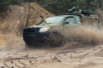 Obraz na płótnie Canvas Protected Patrol Vehicle of British armed forces cruising in dirt . High quality photo