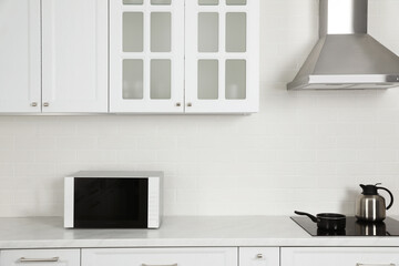 Modern microwave oven on countertop in kitchen