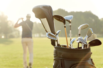 Backpack with putters with man playing golf