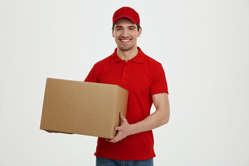 Young caucasian male courier with cardboard box - Powered by Adobe