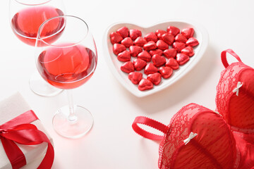 Set for romantic dating,Valentine's day, red love gift, bustier underwear, wine and chocolate sweets on white background.