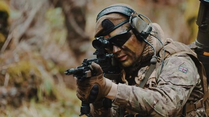 British Army Ranger on the war zone peace mission aiming an automatic rifle with scope. High quality 4k footage