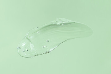 Smear of transparent cosmetic gel on mint background.Copy space for text,mockup concept.